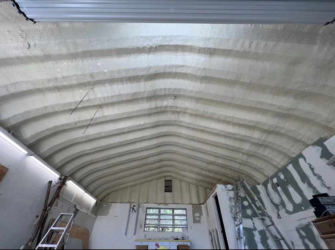 Spray polyurethane foam applied to the underside of a metal roof deck in Brock Hall